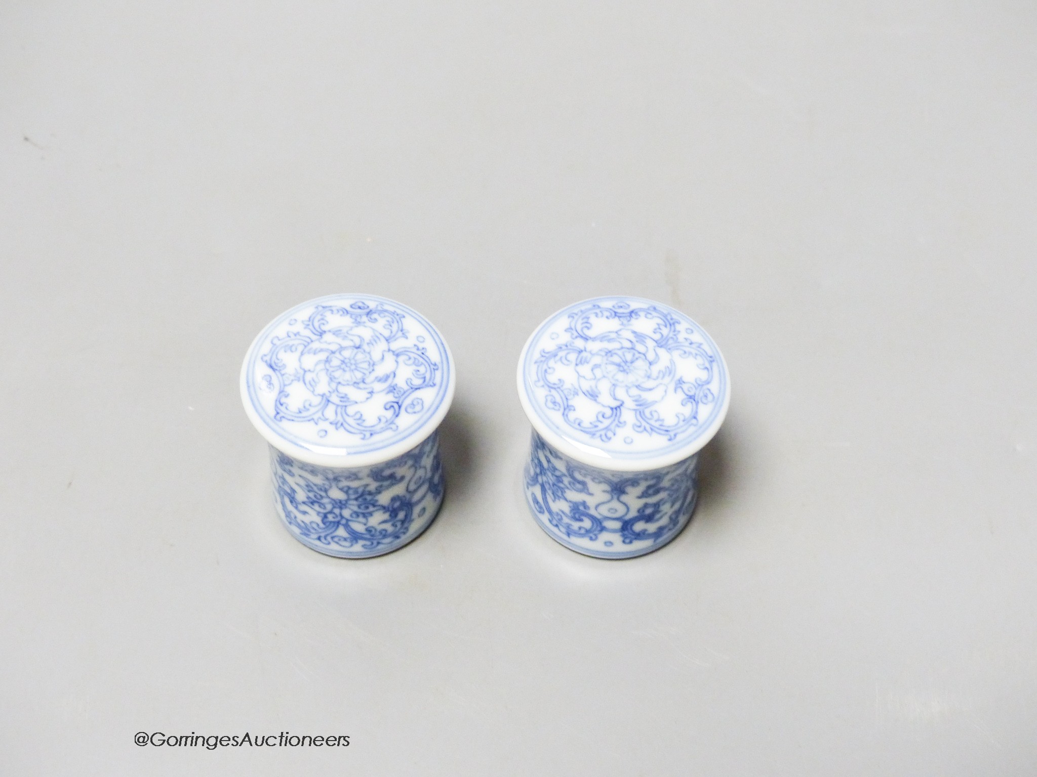 A pair of Chinese blue and white scroll ends, height 3.5cm